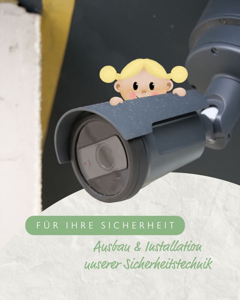 Überwachungskamera mit Glückie-Mädchen als Illustration, Text „Für Ihre Sicherheit“.